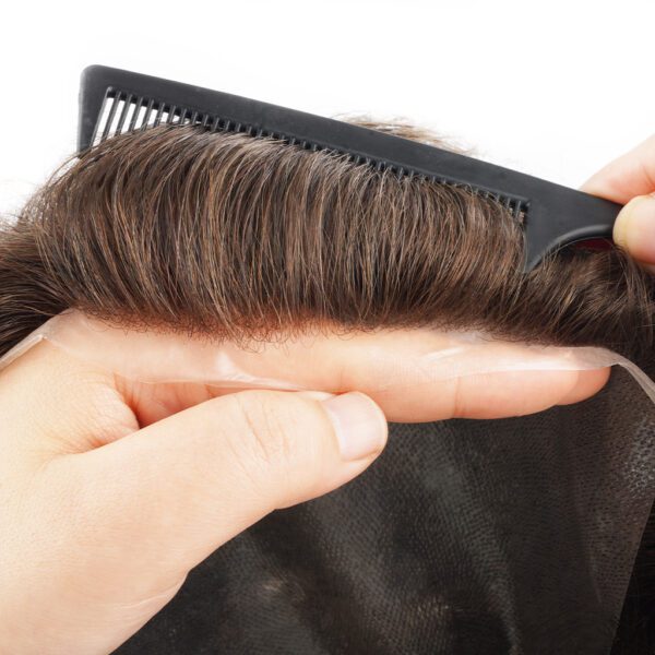 A person with brown hair and comb in their hand.