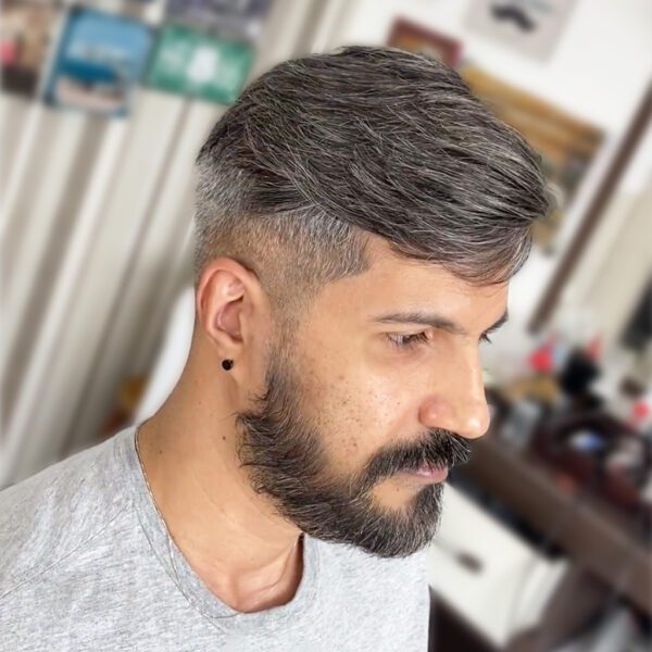 A man with a beard and mustache is looking at the camera.