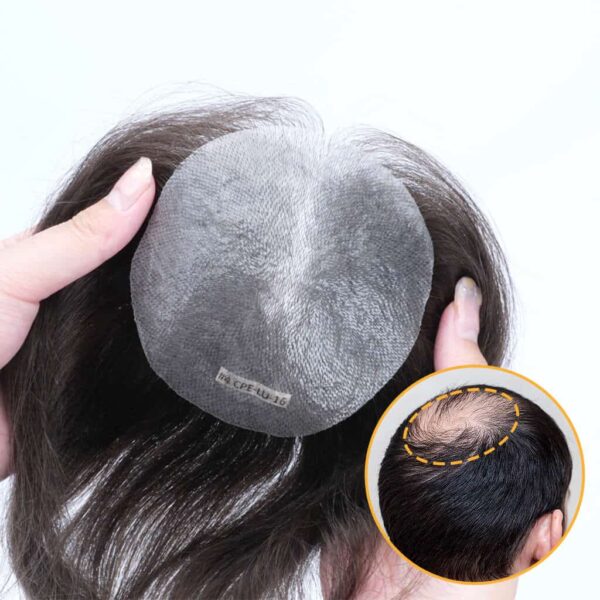 A person holding up a hair piece with a picture of the inside of it.