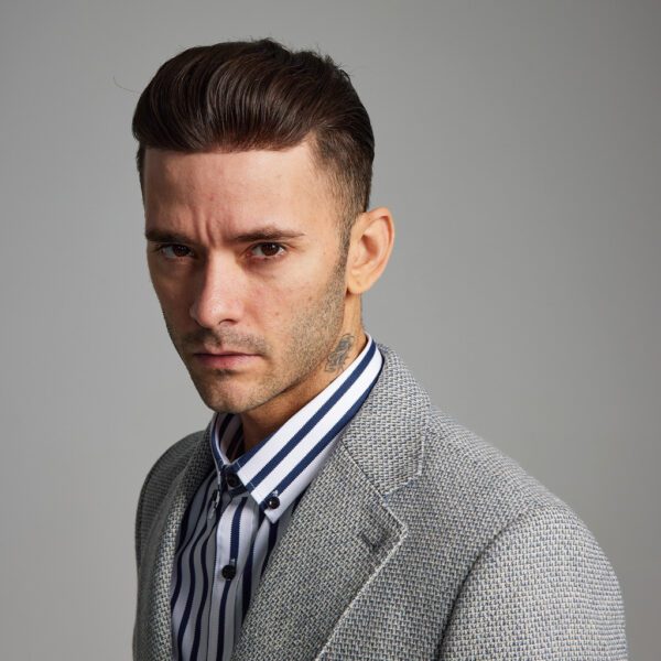 A man with a suit and striped shirt.