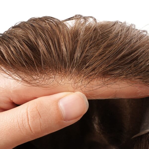 A person is touching the hair of another person.