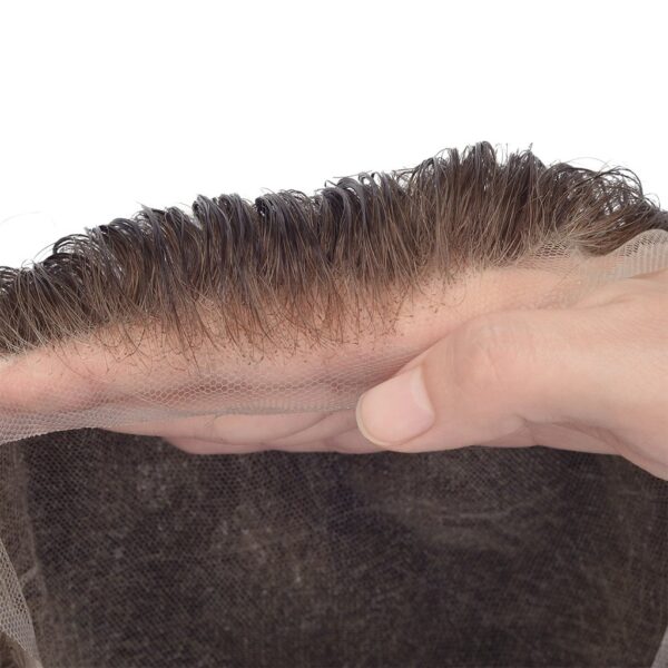 A person holding their hand over the top of a brown hair piece.
